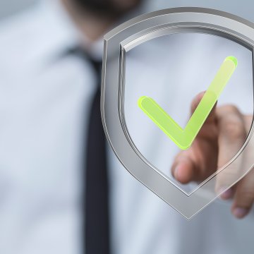 intelius background check service man in shirt and tie touches green checked sign 